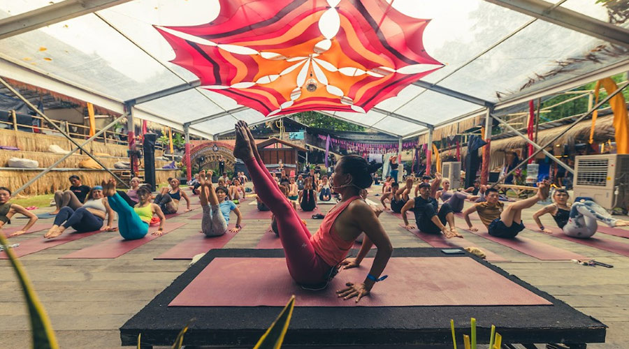 Group yoga with instructor at Bali Spirit Festival