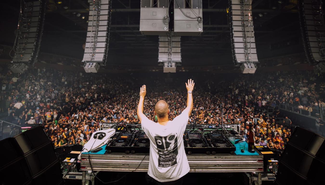 Dombresky behind the DJ console in front of a huge crowd