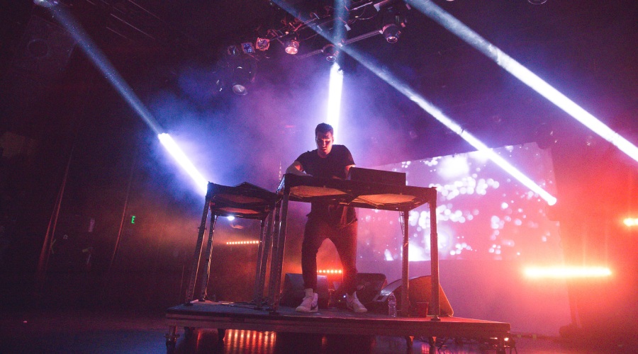 Hayden James at the DJ booth on stage