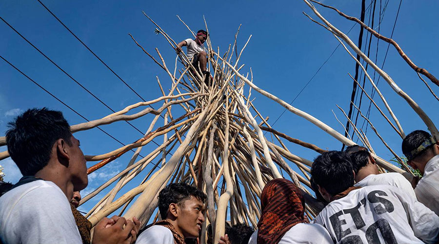 Man on top of sticks during Mekotek festival