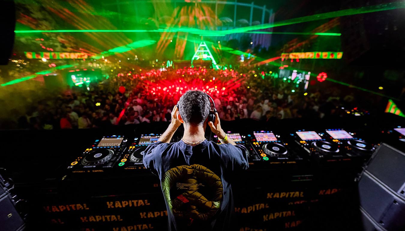 Back view of DJ Priku on the stage