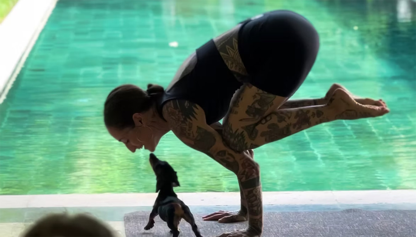 Handstand with the puppy by the pool