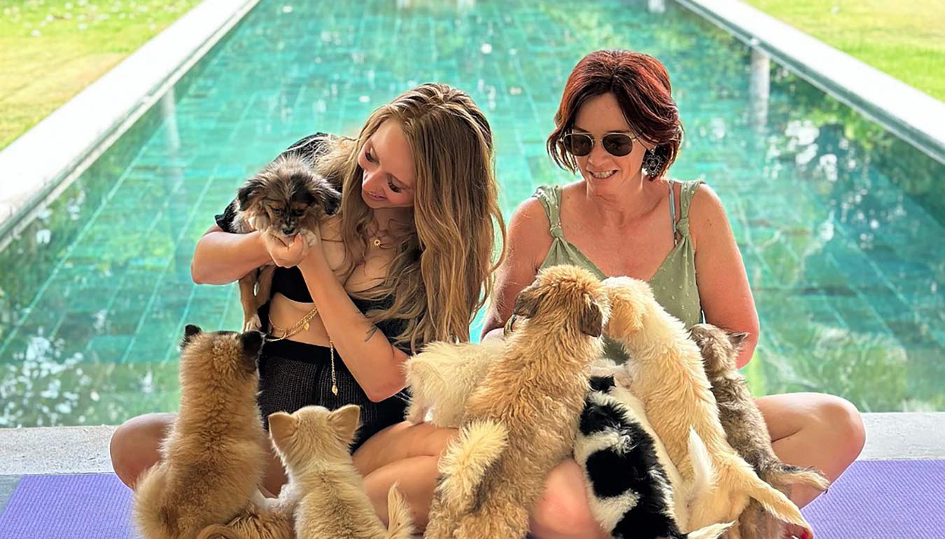 Having fun with puppies during Puppy Yoga Morning