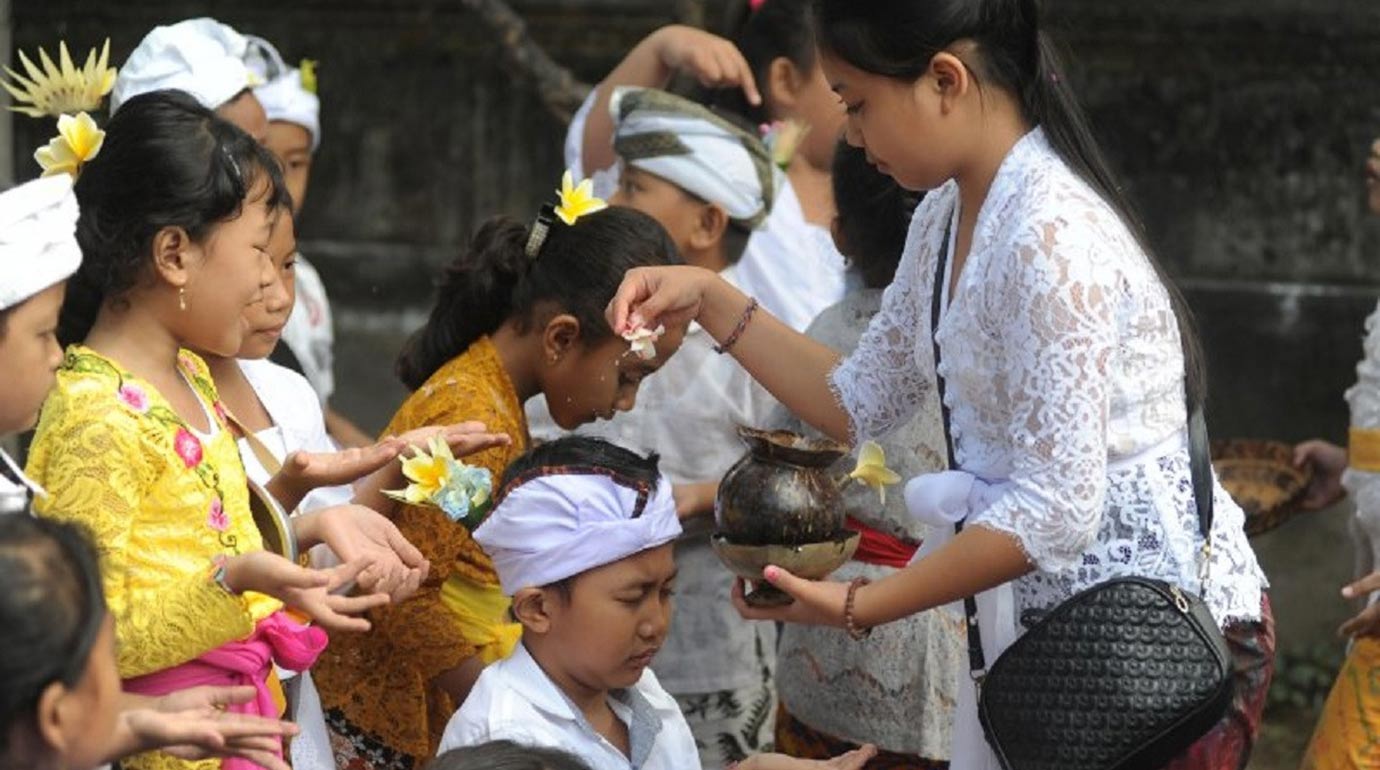Kids taking part in Saraswati Day rituals