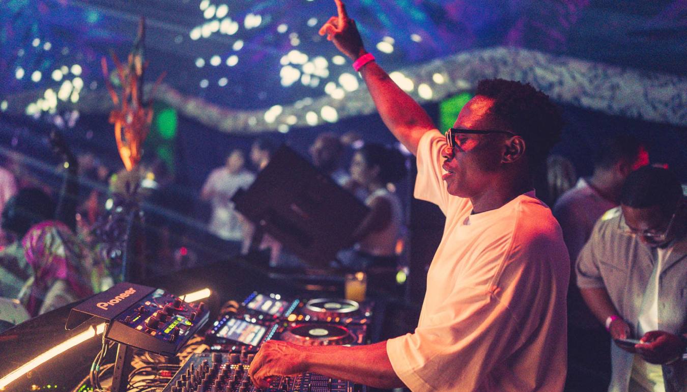 Vanco behind the DJ controller in night club