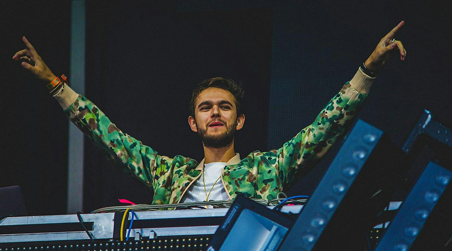 Zedd musician behind the DJ remote control
