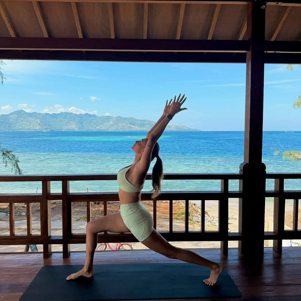 Morning yoga with the ocean and mountains in the background