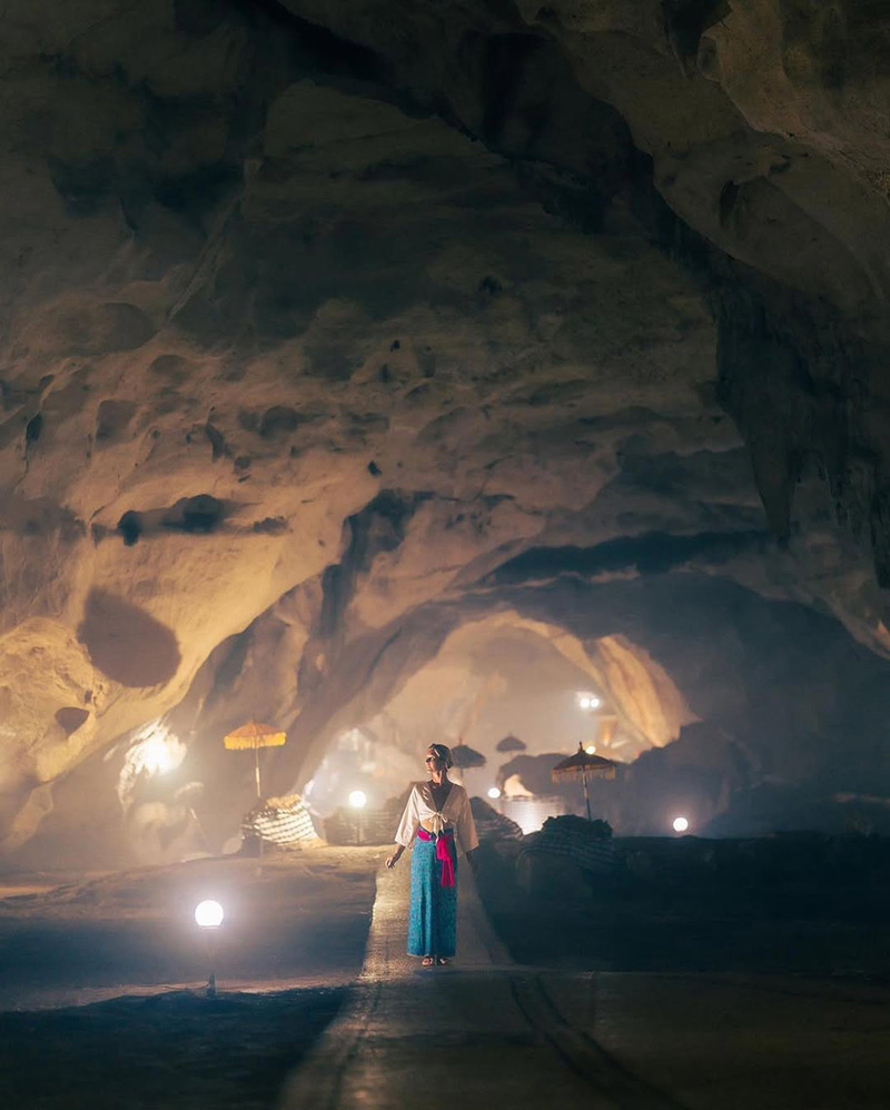 Tourist visiting Goa Giri Putri Cave Temple