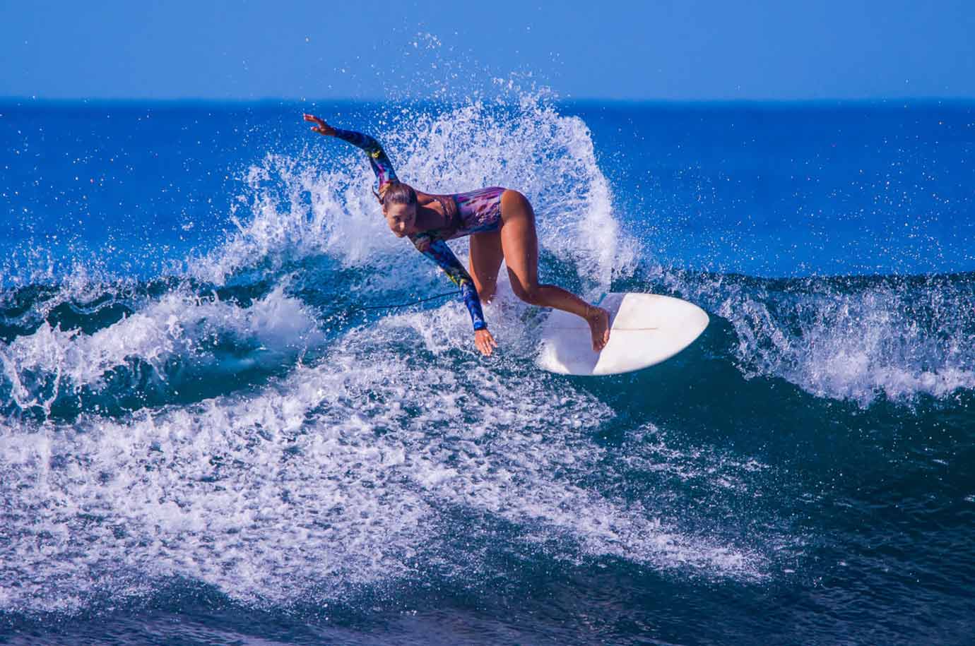 Woman catching the wave in Seminyak