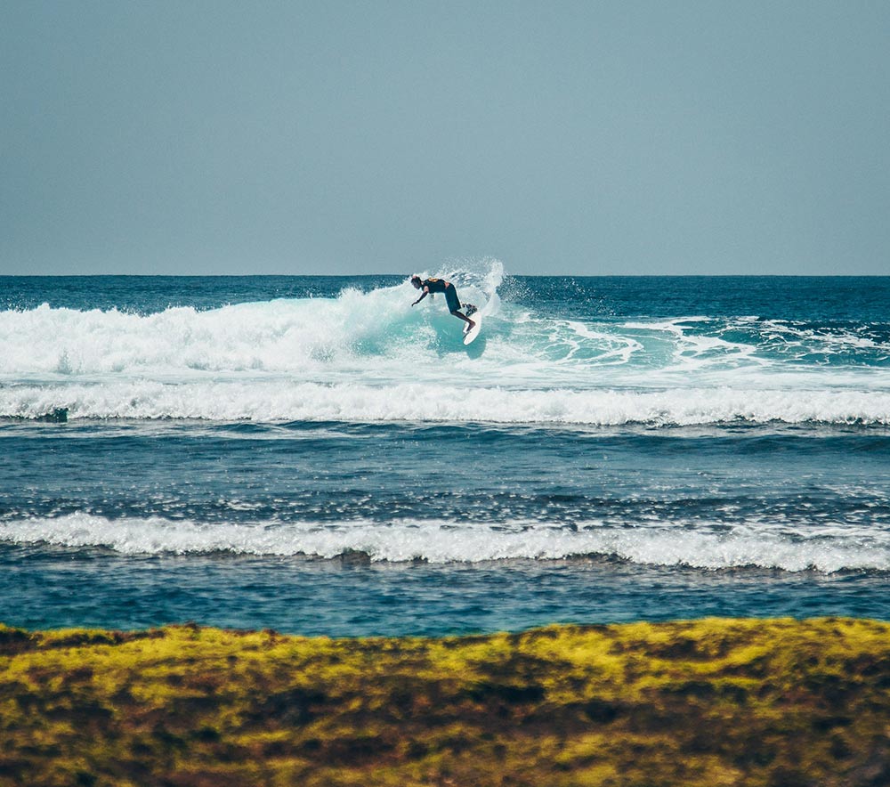 Surfing near the beach in Uluwatu