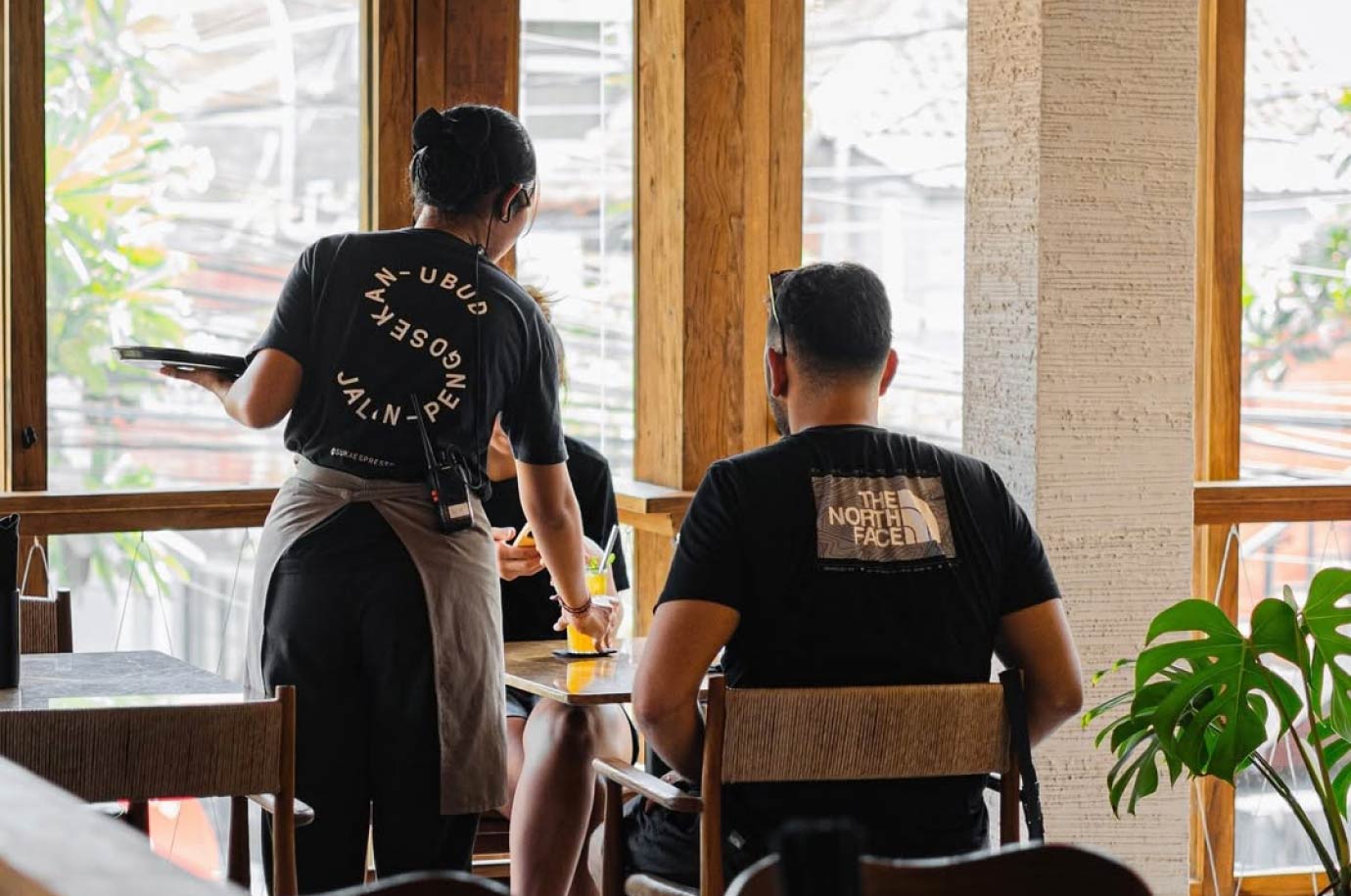 Guests and waitress in the Suka Espresso restaurant