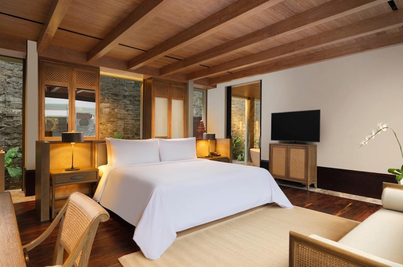 Minimalist bedroom with wooden furniture in The Apurva Kempinski Bali