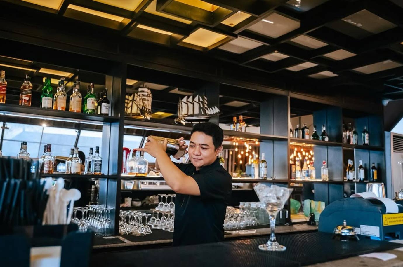 Barman with cocktail in the The Seven Rooftop Bar