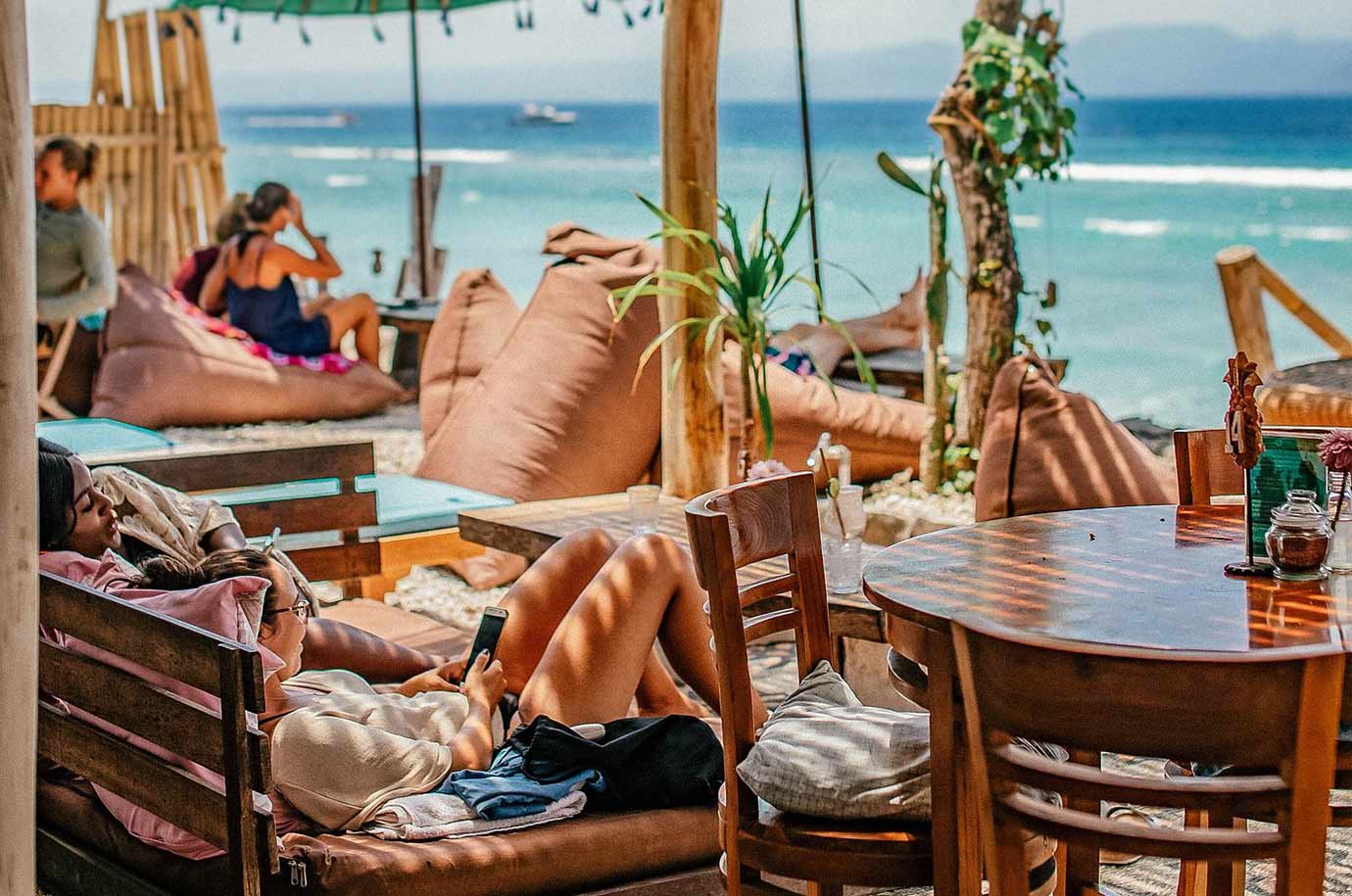 Wooden seats from Penida Colada Beach Bar