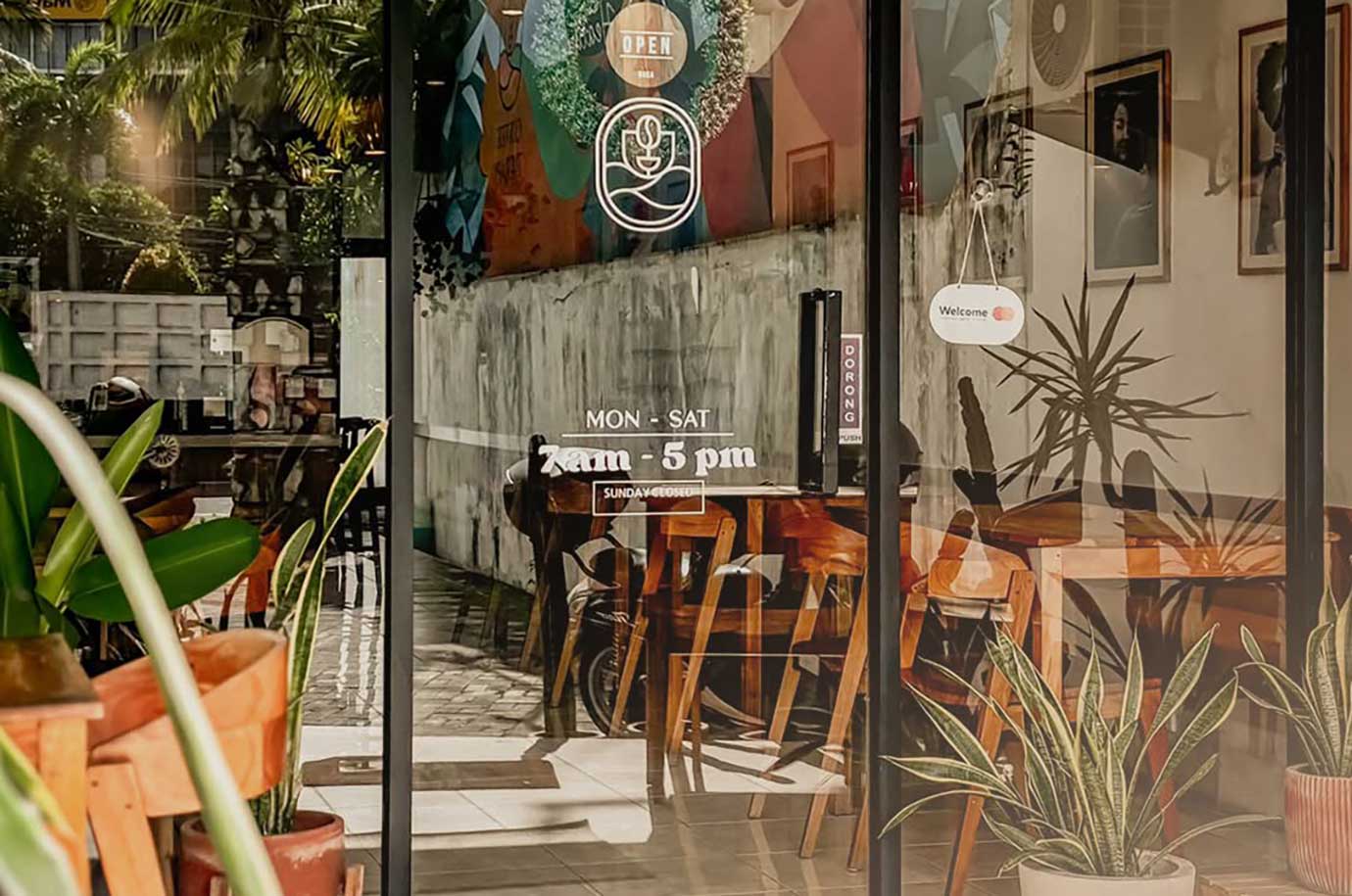 Glassed door and interior inside The Coffee Therapy Sanur