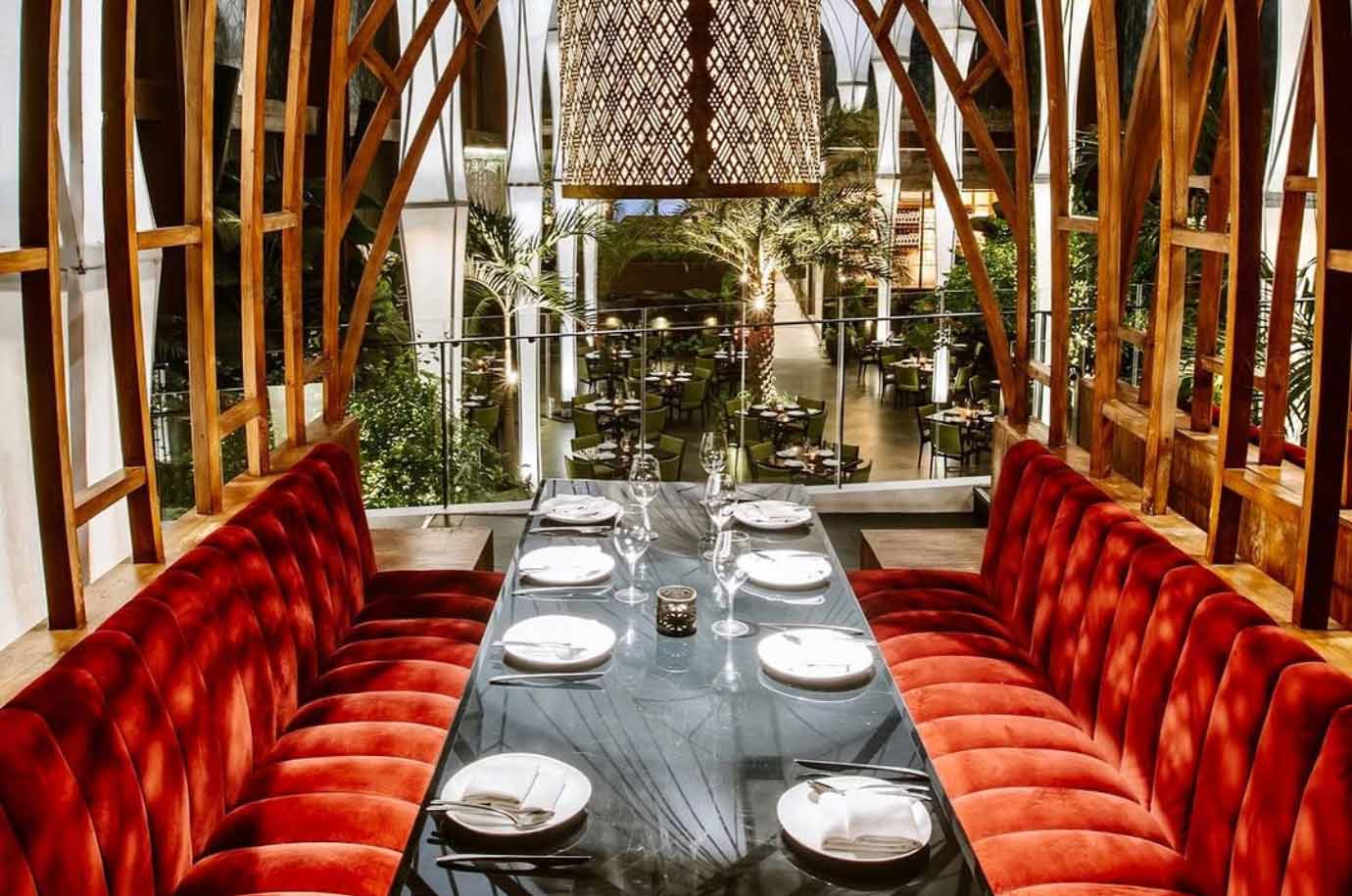 Served table and red sofas in the Merah Putih restaurant