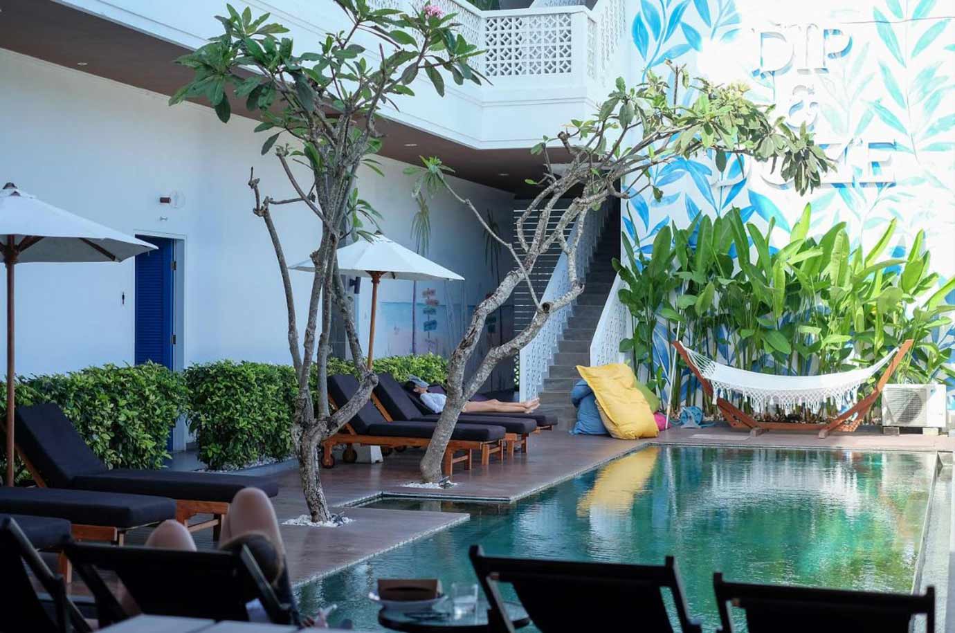 Sunbeds near pool in the Dip & Dose Boutique Hostel