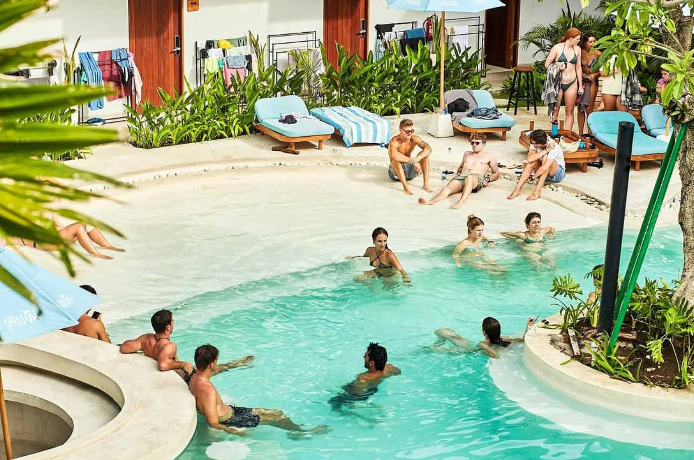 The swimmin pool with guests in the Lay Day Surf Hostel