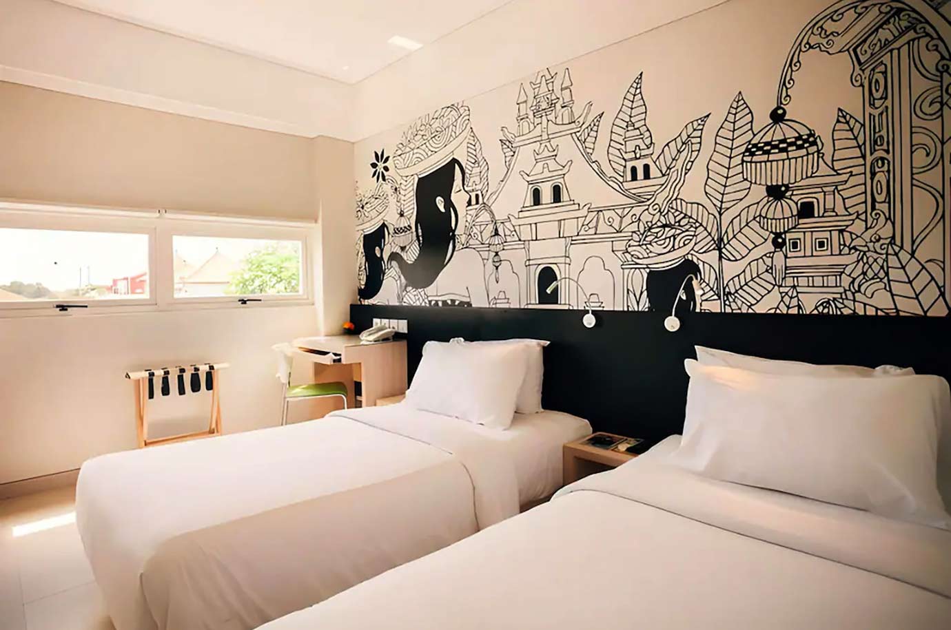 White colored bedroom with the drawings in Grandmas Plus Hotel Airport