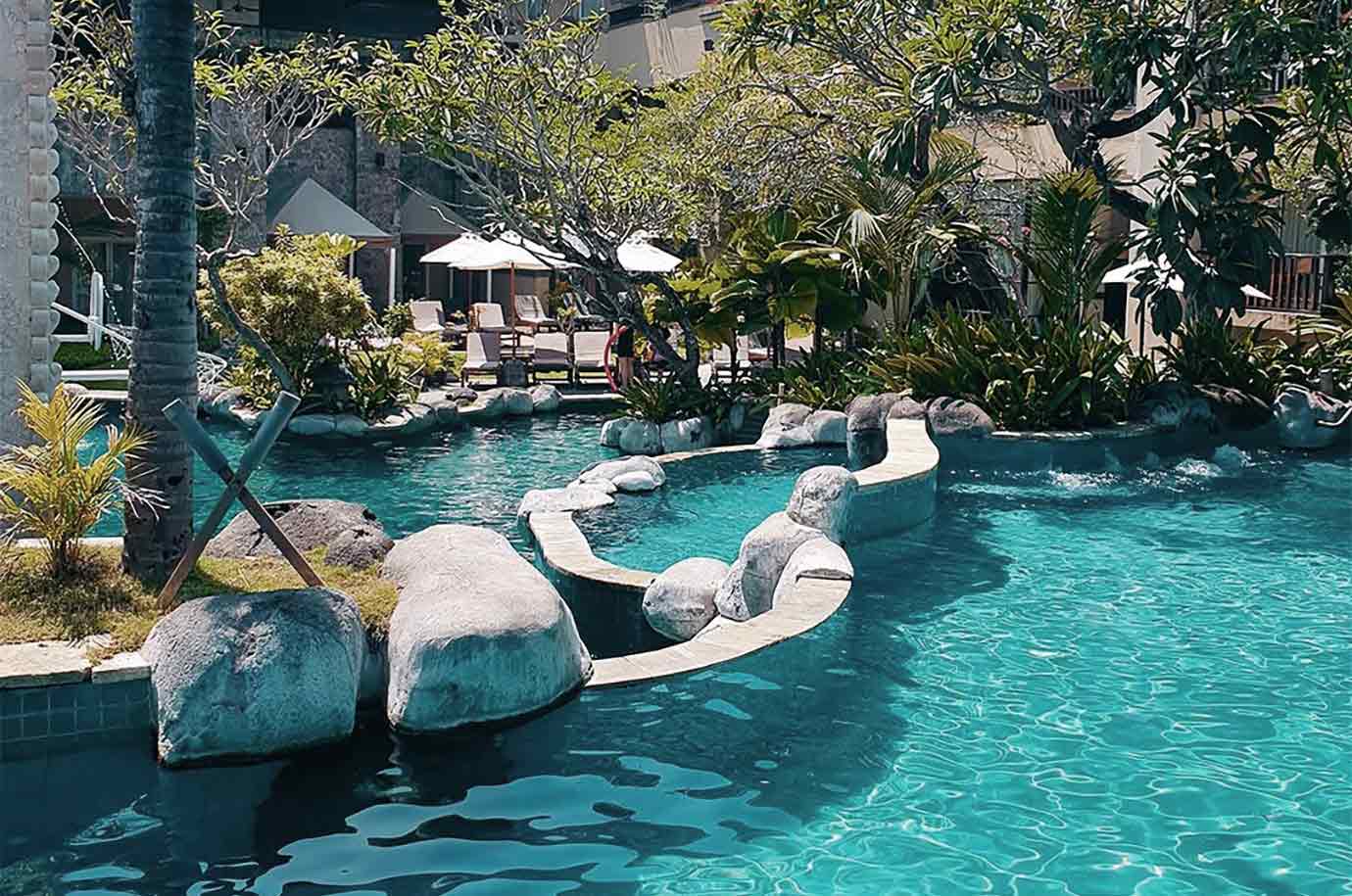 Kuta Paradiso Hotel - the pool surrounded with the stones and garden