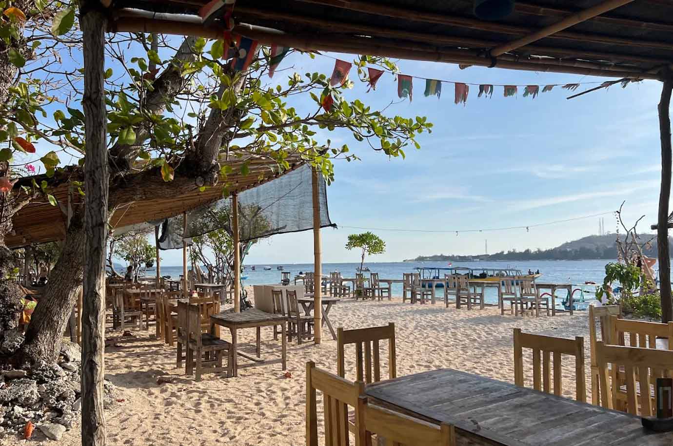 Wooden tables and seats of Malfina Beach Bar & Resto