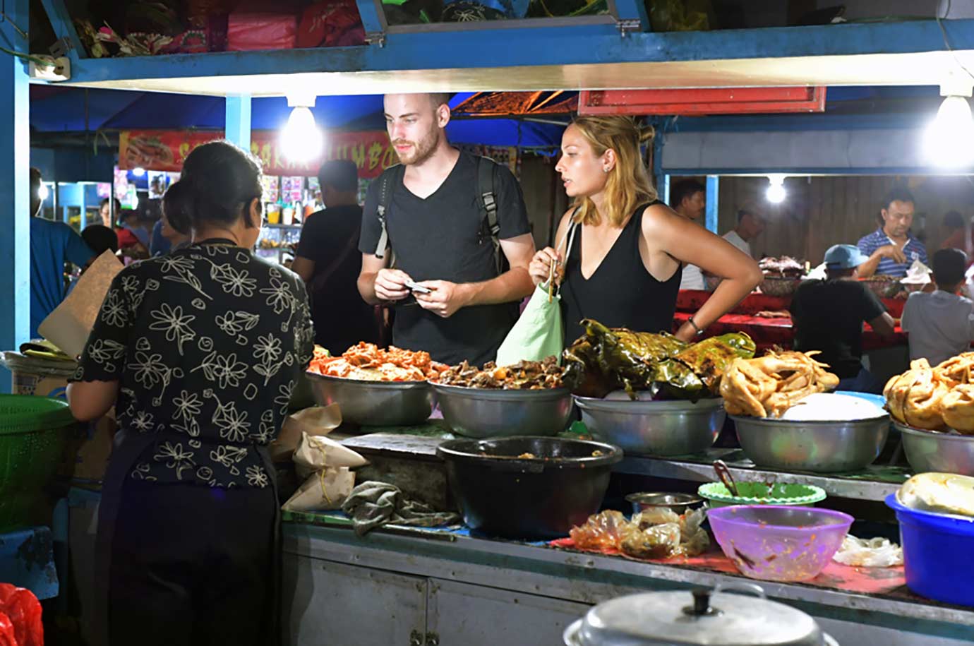 Buyers at butcher shop in Gianyar Night Market