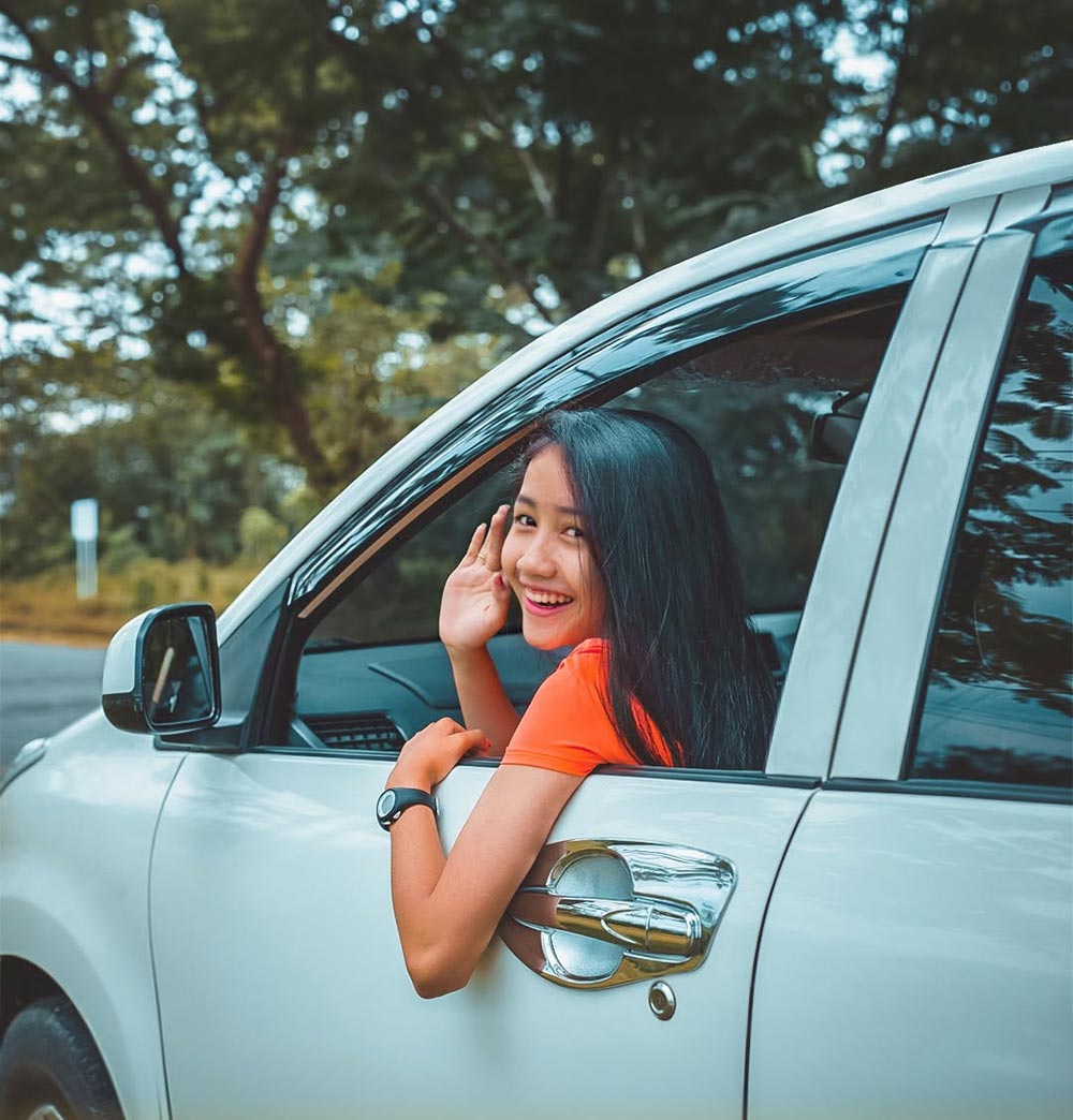 Woman driving car rented at Drive-In Bali company