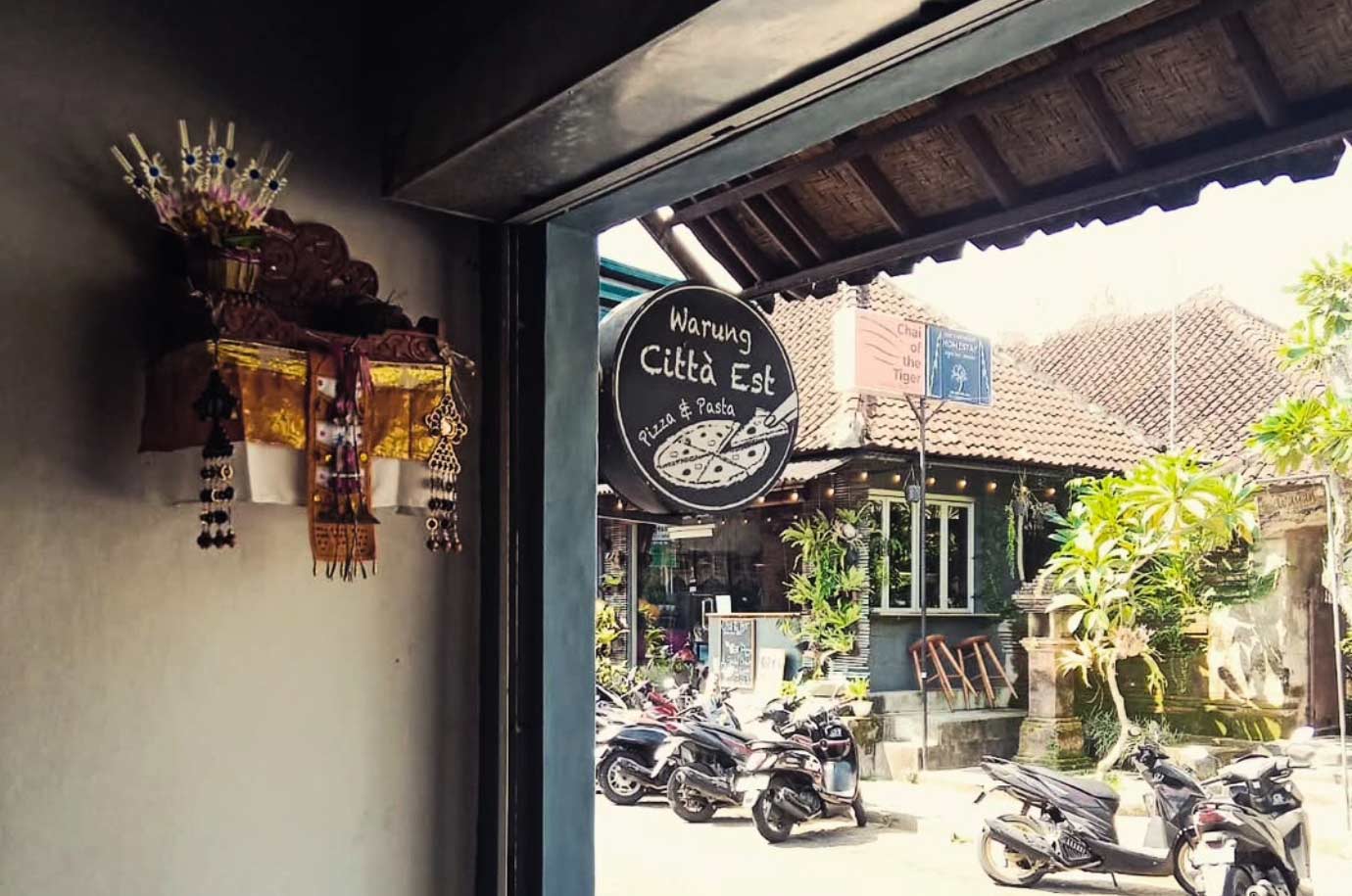 Signboard and parking in the Warung Citta Ovest Pizza & Pasta