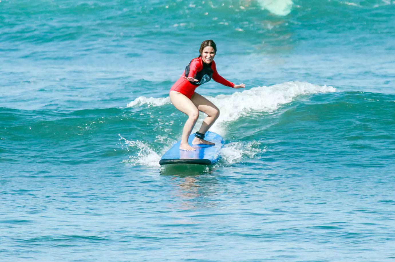Woman having surf lessons from Sea N surf — Surf School