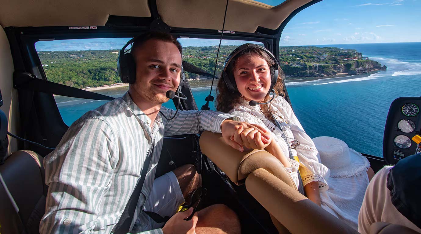 Couple of tourists in the cabin of helicopter