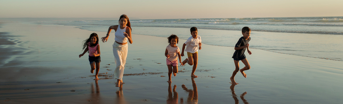 Family is running near the ocean and the Best Family-friendly Hotels in Bali
