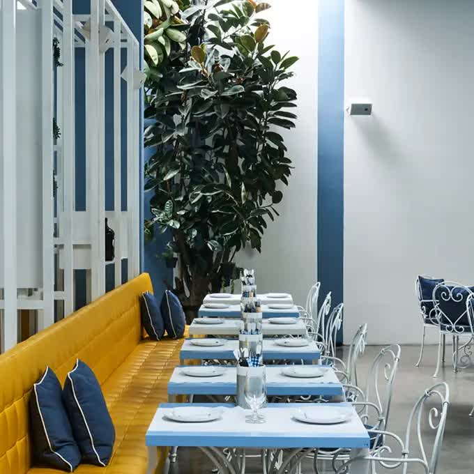 Interior of an Italian restaurant in blue, yellow and white colors