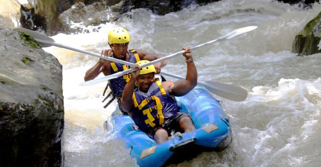 Two men are experiencing rafting along Melangit River