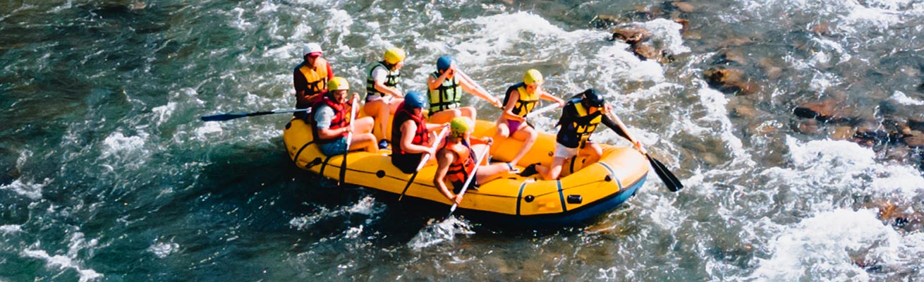 Eight people is rafting in Ubud on yellow inflatable boat