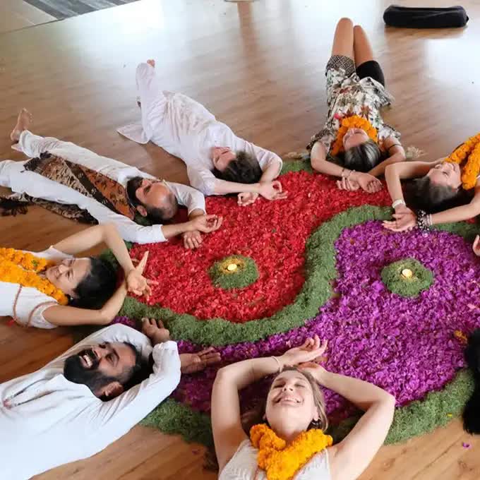 People lying on the floor in a circle and practicing yoga