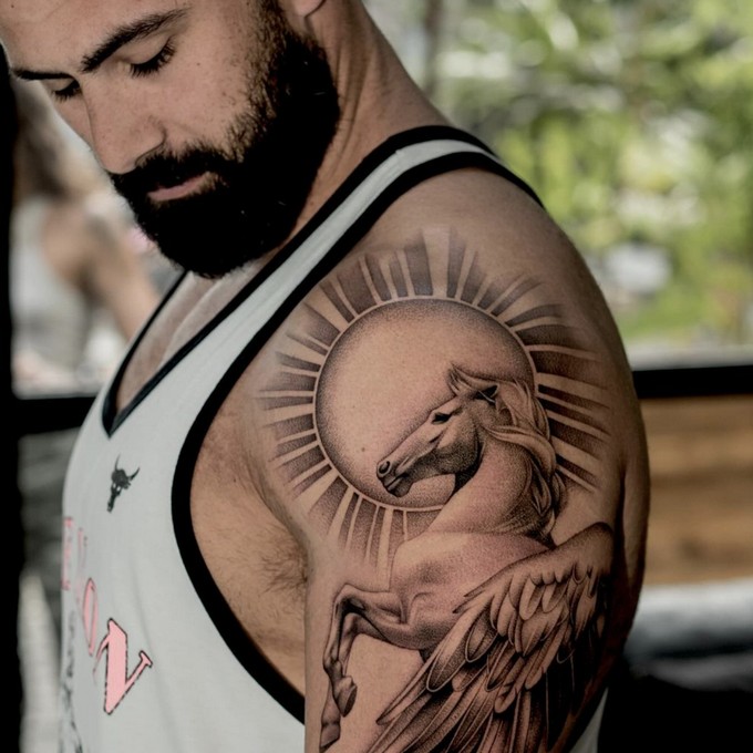 Charlie Rose Tattoo Studio - a tattoo in the form of a horse on the man's arm