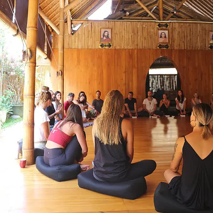 People sitting in a circle at a yoga class