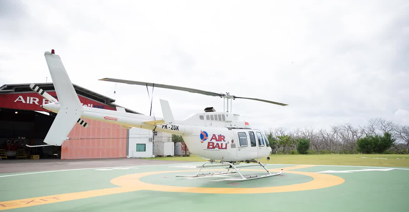 Air Bali parking lot and a big white helicopter with their logo