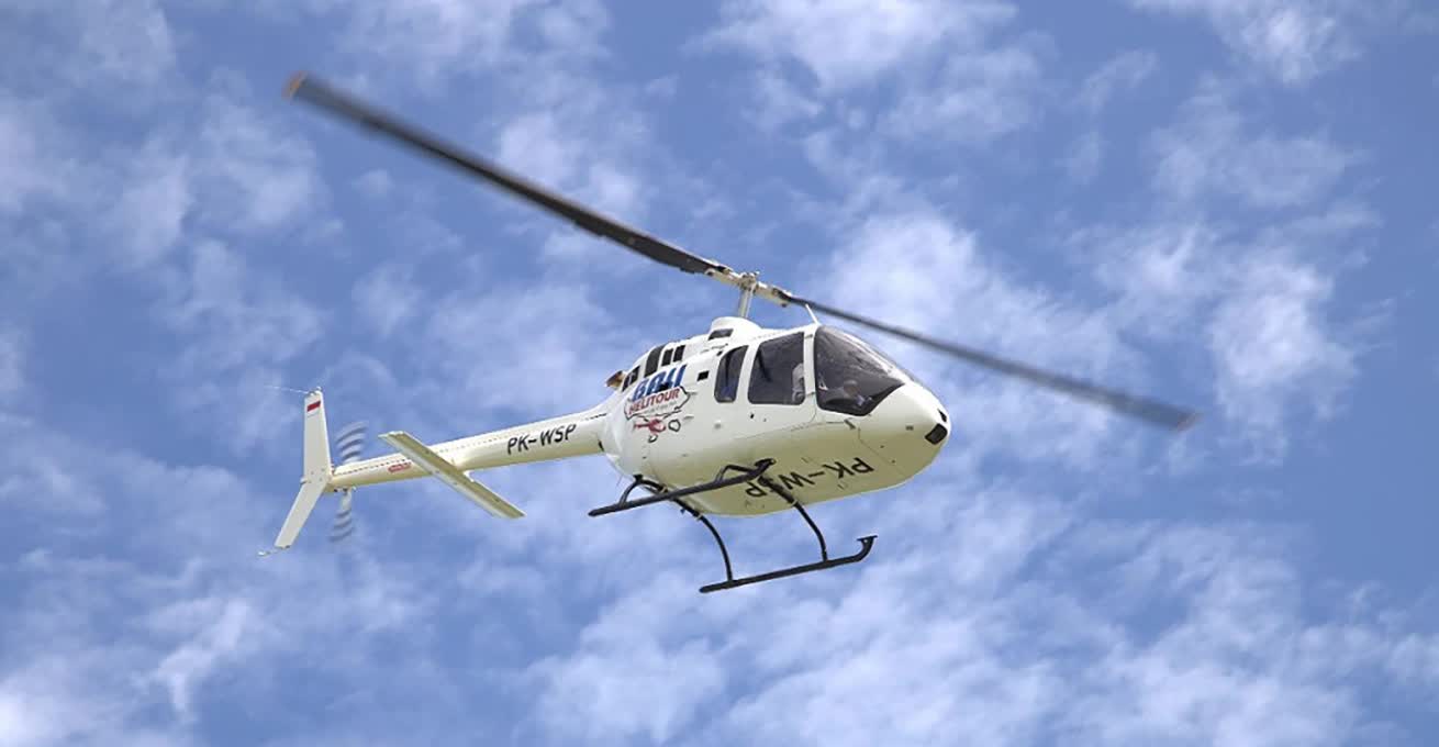 Bali Helitour helicopter is flying in the clouds