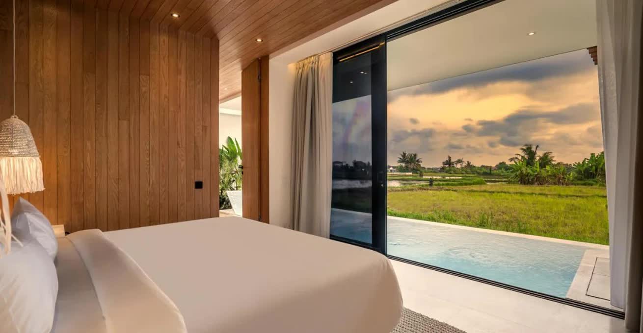 Bedroom with the access to the pool and views of green fields at Green Flow Villas