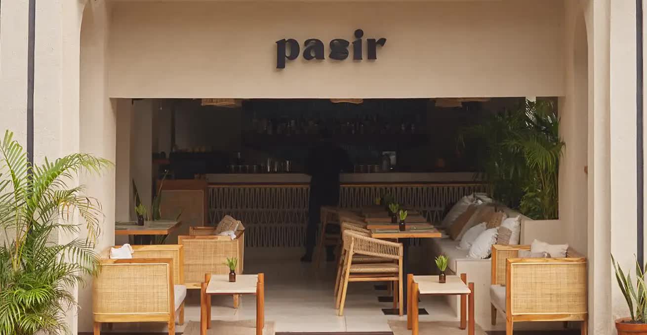 Outdoor area of Pasir Bali restaurant with tables and chairs 