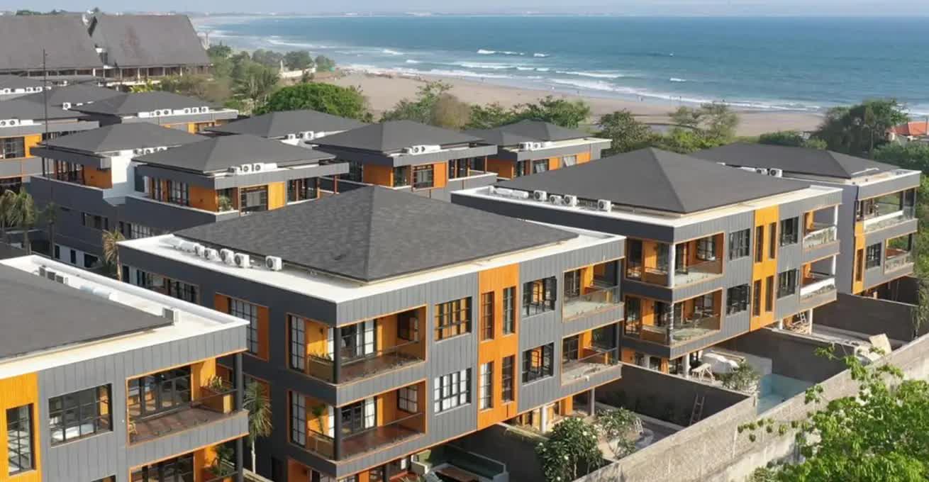 Secana Beachtown gray and yellow buildings that are located right by the sea