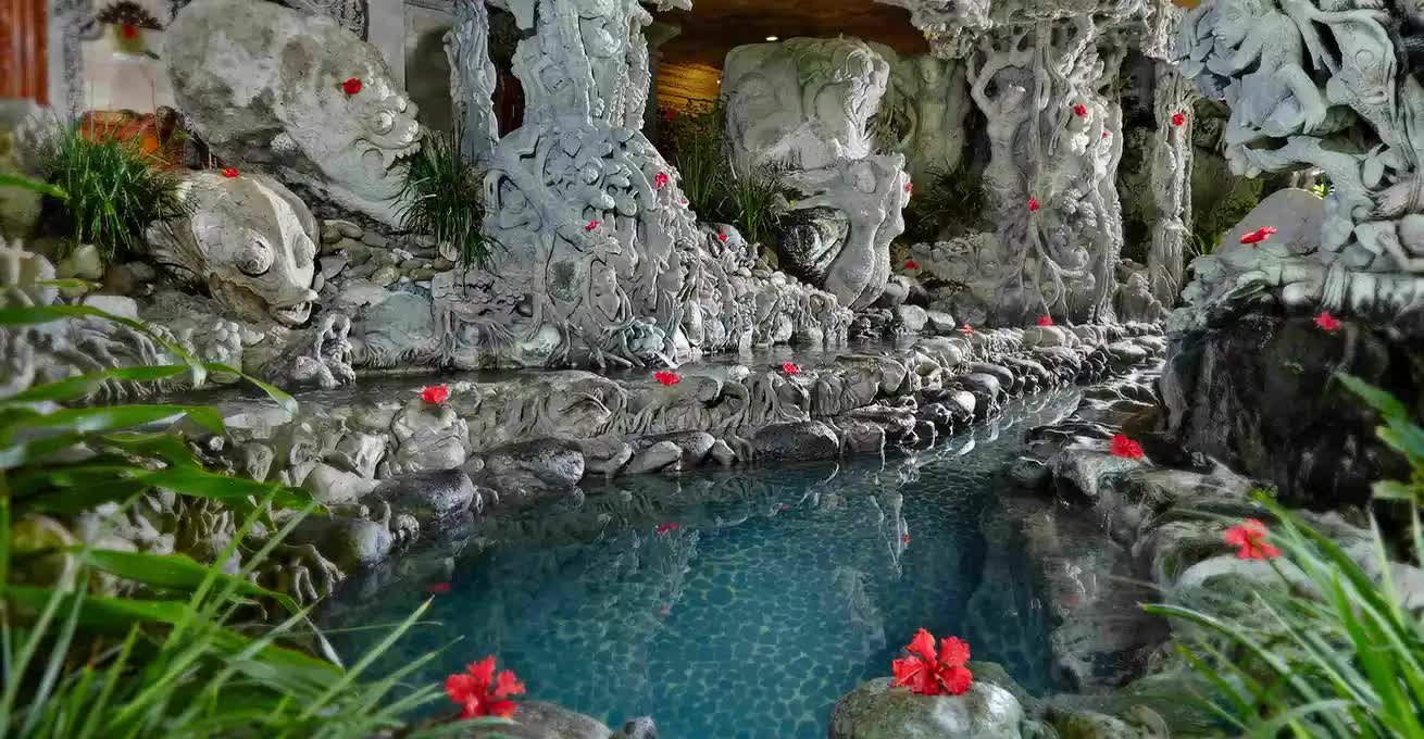 Water jacuzzis with sculptures and flowers at Tjampuhan Spa