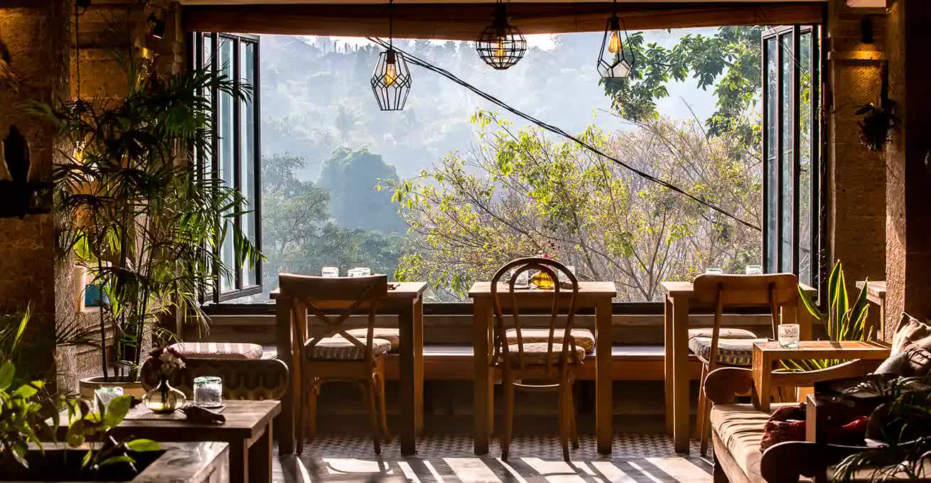Wooden chairs and tables overlooking the forest in Bali