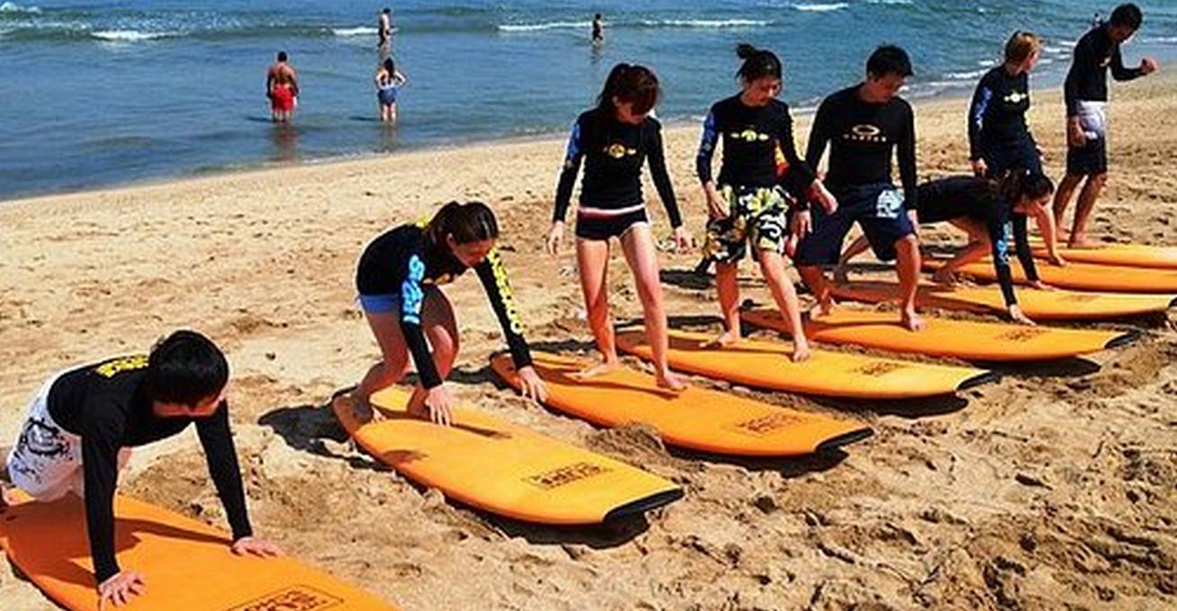 Beginners learn how to surf