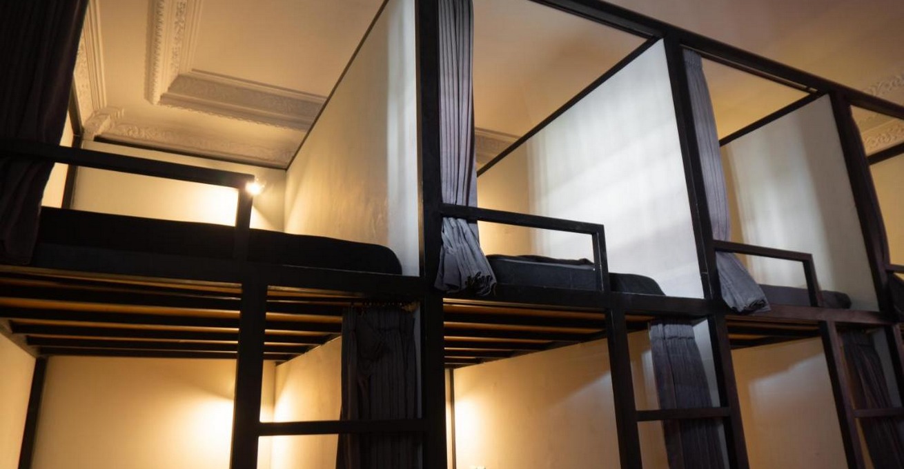 Bunk beds with curtains at Sunshot Hostel