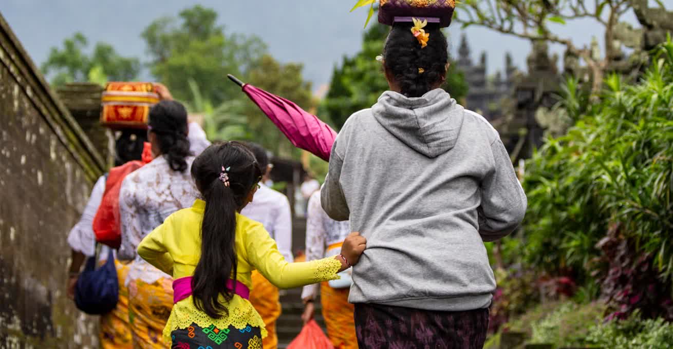 A woman and her daughter are going to a celebration of Nyepi